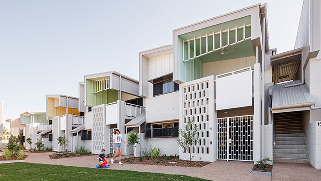A street of tightly packed two-story houses